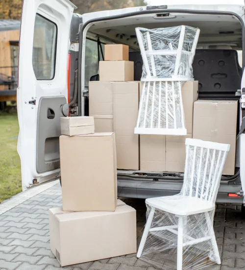 car-trunk-full-of-boxes-near-a-house-outdoors-2025-03-16-05-24-54-utc